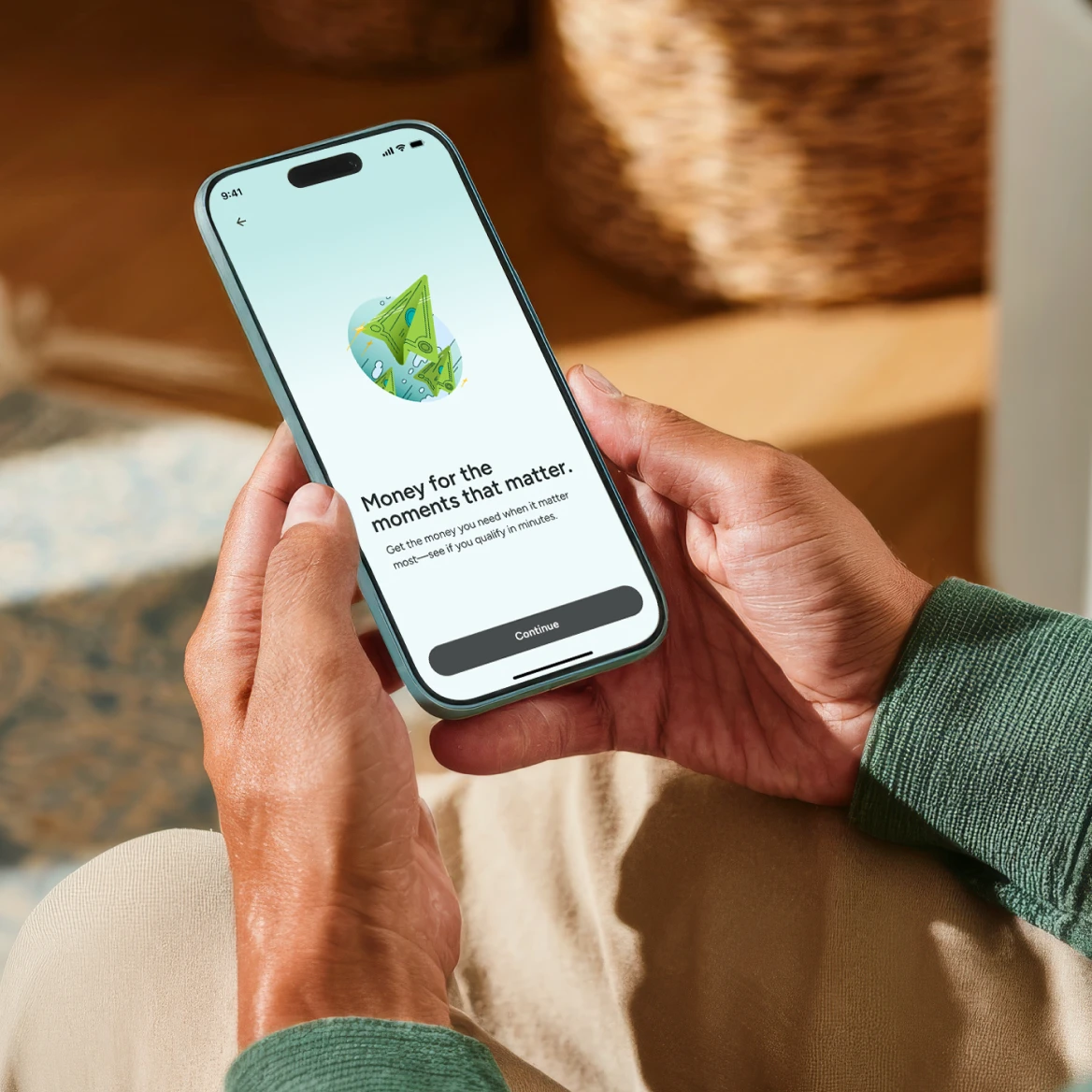 Upstart loan application displayed on a smartphone held in both hands
