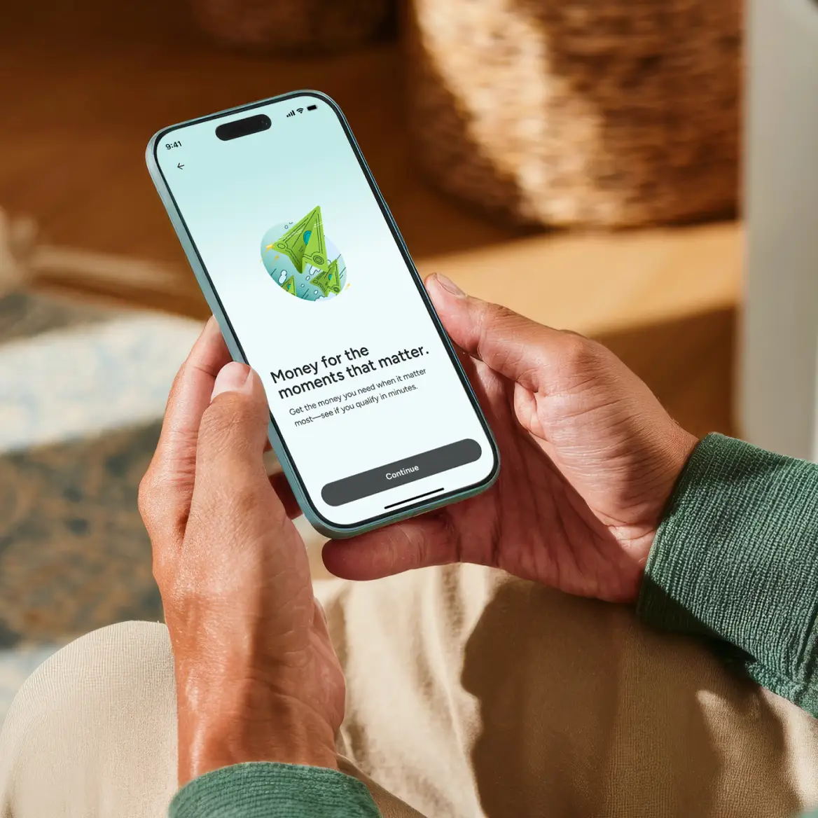 Upstart loan application displayed on a smartphone held in both hands